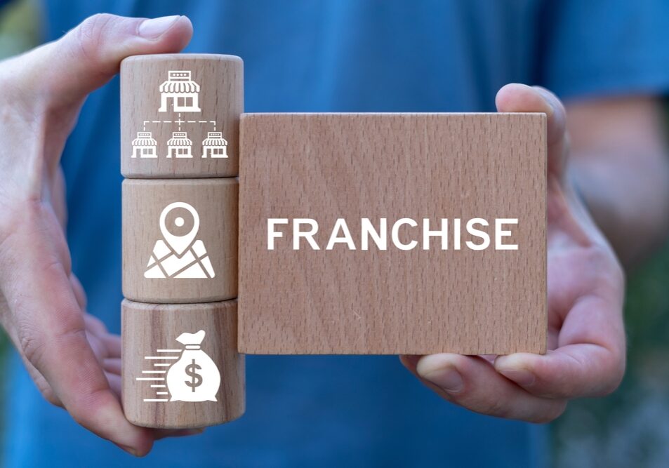 Man,Holding,Wooden,Blocks,Sees,Word:,Franchise.,Franchise,Business,Concept.