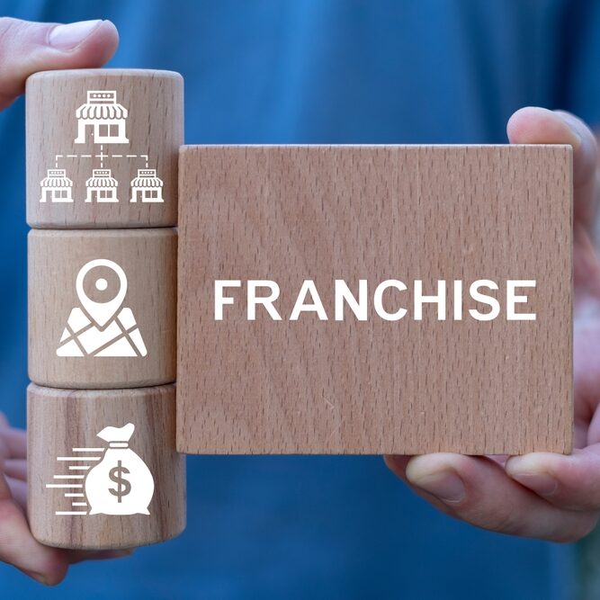 Man,Holding,Wooden,Blocks,Sees,Word:,Franchise.,Franchise,Business,Concept.