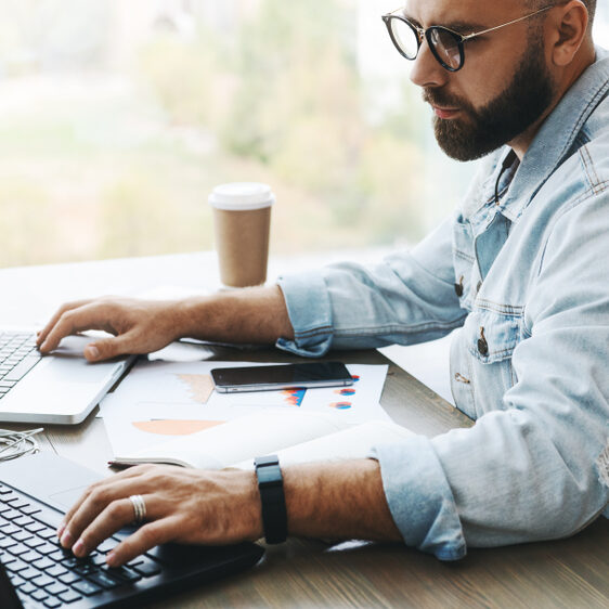 Side,View.,Hipster,Bearded,Businessman,Sits,In,Cafe,,Modern,Office,